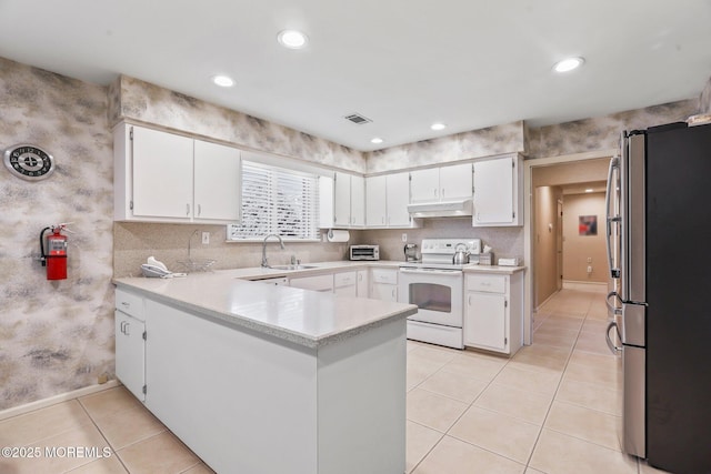 kitchen featuring white electric stove, light countertops, freestanding refrigerator, white cabinets, and under cabinet range hood