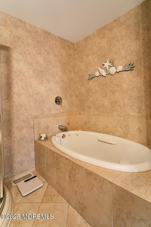 bathroom featuring tile patterned floors and tiled bath