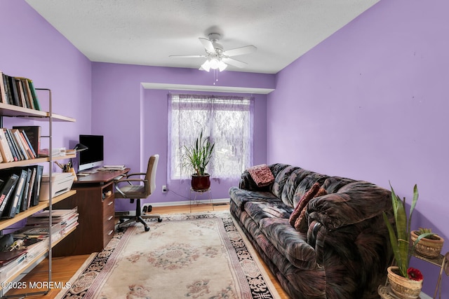 office featuring a textured ceiling, hardwood / wood-style flooring, and ceiling fan