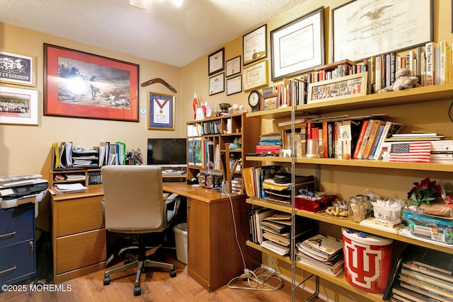 office with a textured ceiling and hardwood / wood-style floors