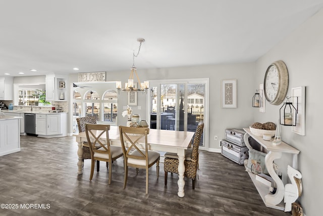 dining area with recessed lighting, baseboards, an inviting chandelier, and dark wood-style floors