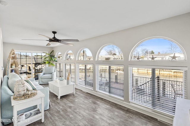 sunroom / solarium featuring a healthy amount of sunlight and ceiling fan