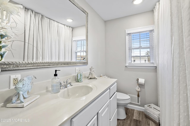 bathroom featuring vanity, wood finished floors, visible vents, recessed lighting, and toilet