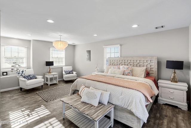 bedroom with recessed lighting, visible vents, baseboards, and wood finished floors