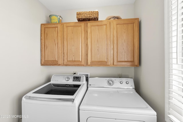 laundry area with washing machine and dryer and cabinet space