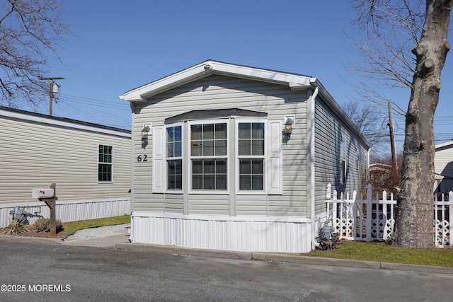 view of side of property featuring fence