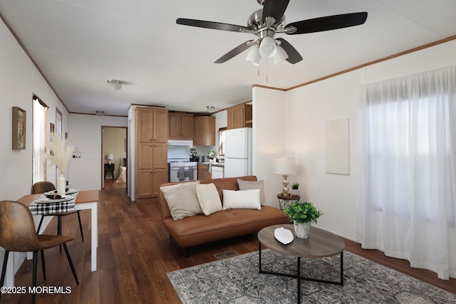 living room featuring dark wood-style floors, visible vents, crown molding, and baseboards