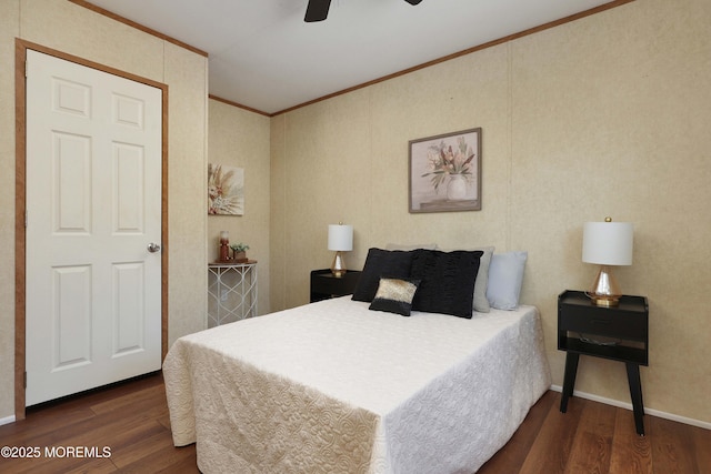 bedroom featuring a ceiling fan, crown molding, baseboards, and wood finished floors