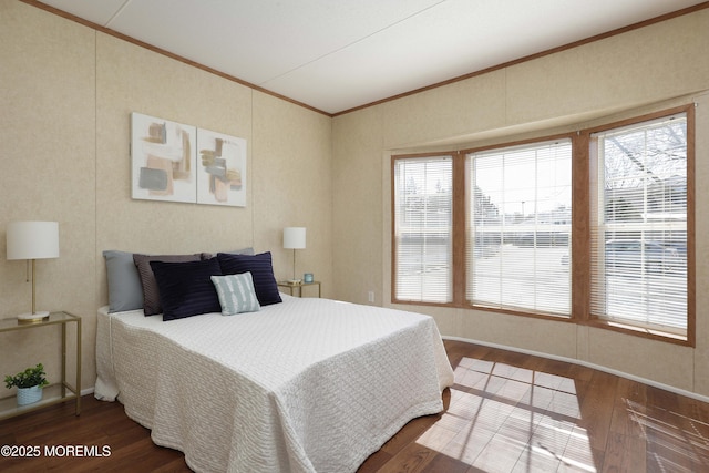 bedroom featuring crown molding and wood finished floors