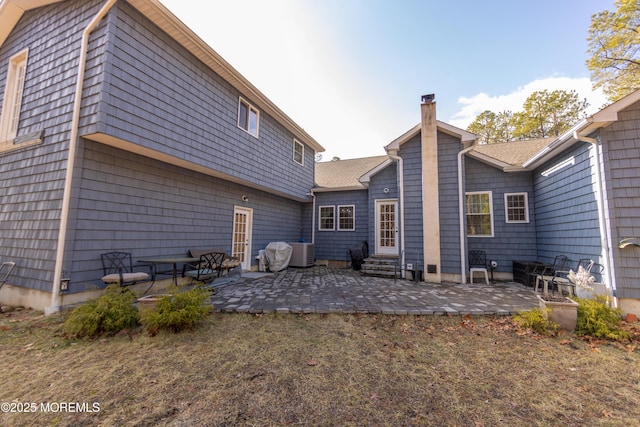 rear view of property featuring a patio