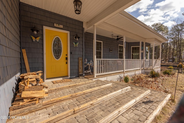 entrance to property featuring ceiling fan and covered porch