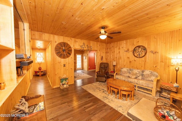 living room with wood ceiling, ceiling fan, hardwood / wood-style floors, and wood walls