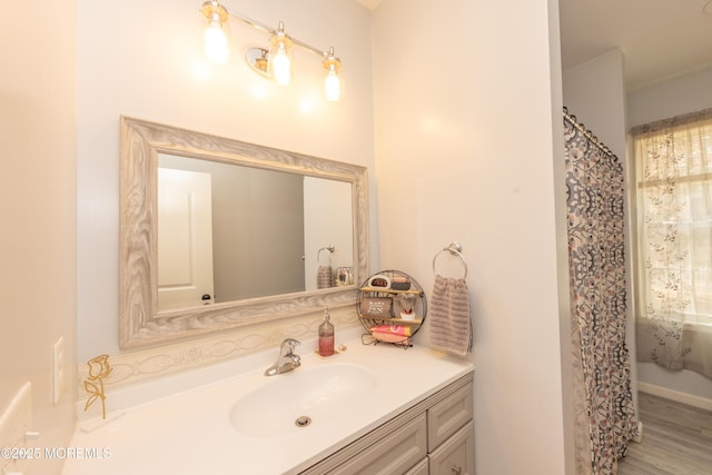 bathroom featuring vanity, curtained shower, and hardwood / wood-style floors