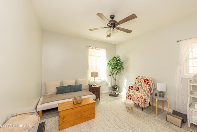 living area featuring ceiling fan and light wood-type flooring
