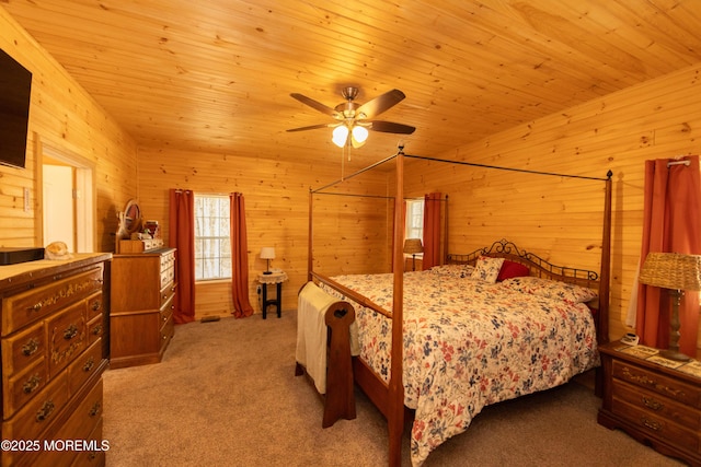 carpeted bedroom with vaulted ceiling, wood ceiling, and wood walls