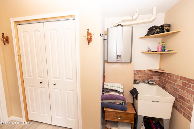 interior space with tankless water heater and sink