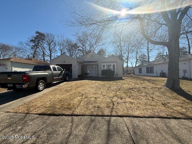 view of front of home with a garage and a front lawn