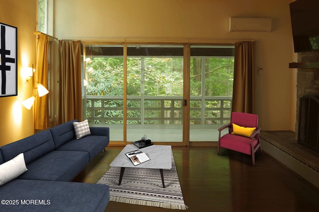 living room with a fireplace, a wall mounted AC, and healthy amount of natural light