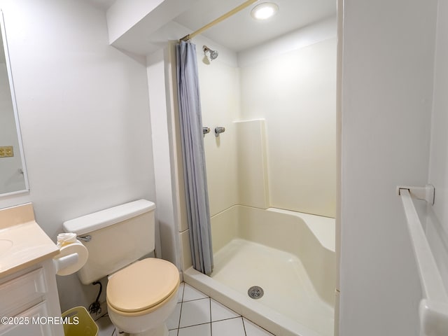 full bathroom with a shower stall, vanity, toilet, and tile patterned floors