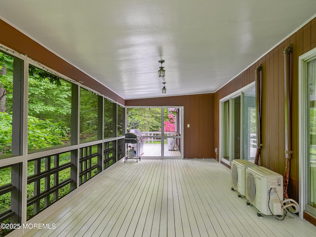 deck with a grill, covered porch, and ac unit