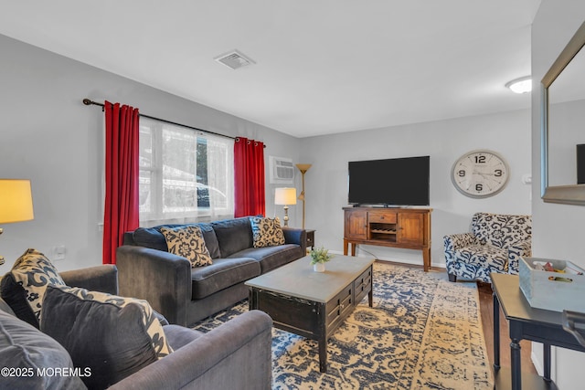 living room featuring an AC wall unit and hardwood / wood-style flooring