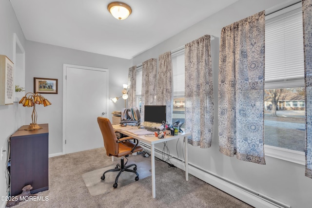 office space with a baseboard heating unit and carpet floors