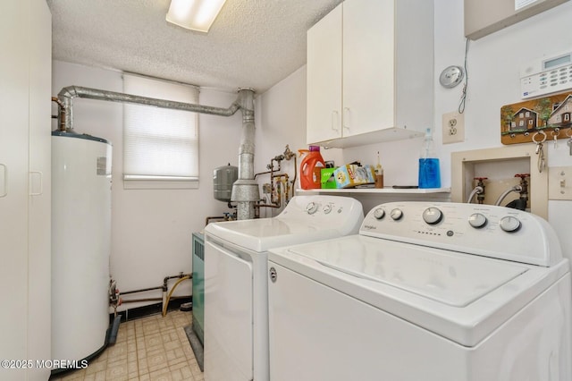 washroom featuring gas water heater, light floors, cabinet space, a textured ceiling, and separate washer and dryer