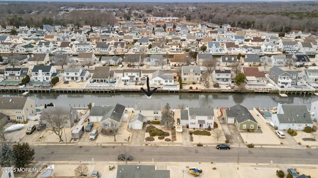 drone / aerial view with a water view and a residential view