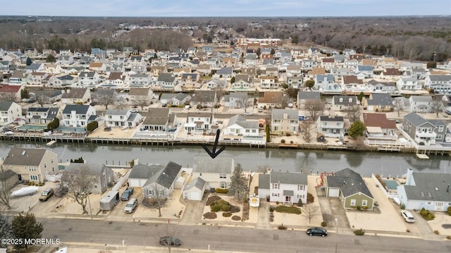 drone / aerial view featuring a water view and a residential view