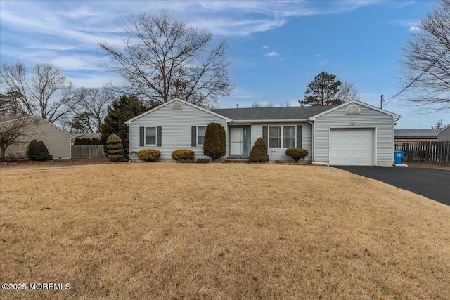 ranch-style home with a garage, aphalt driveway, a front lawn, and fence