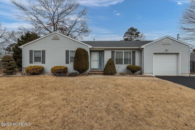 ranch-style house with an attached garage, roof with shingles, aphalt driveway, and a front yard