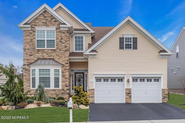 craftsman inspired home with a garage, stone siding, driveway, and a shingled roof