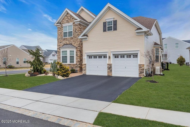 view of front facade with aphalt driveway, stone siding, an attached garage, and a front lawn