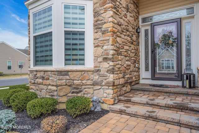 entrance to property featuring stone siding