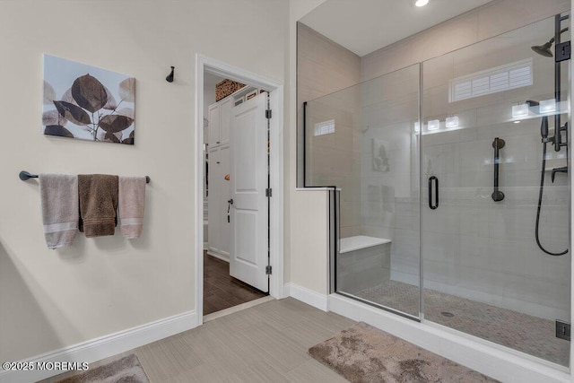 full bathroom featuring baseboards and a stall shower