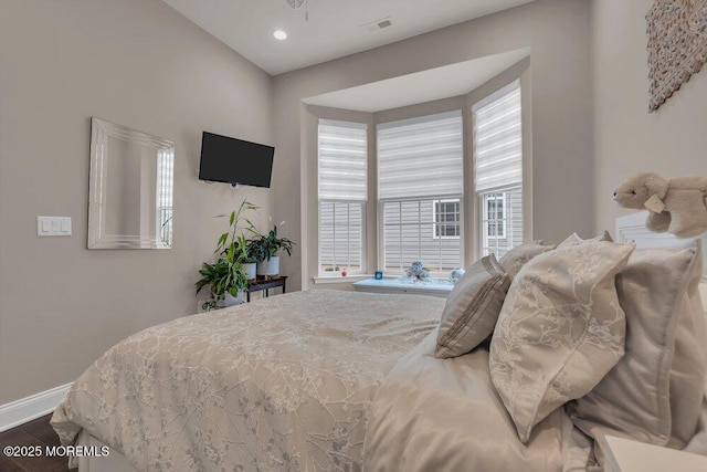 bedroom with recessed lighting, visible vents, baseboards, and wood finished floors