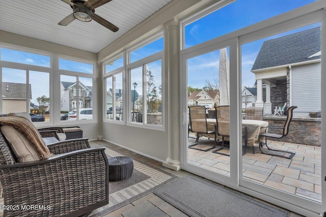 sunroom / solarium with a ceiling fan