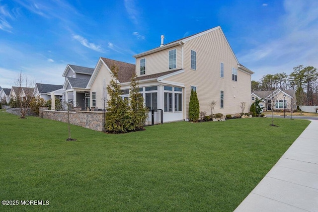 back of house featuring a lawn