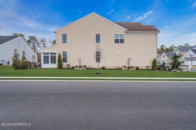 back of house featuring a lawn