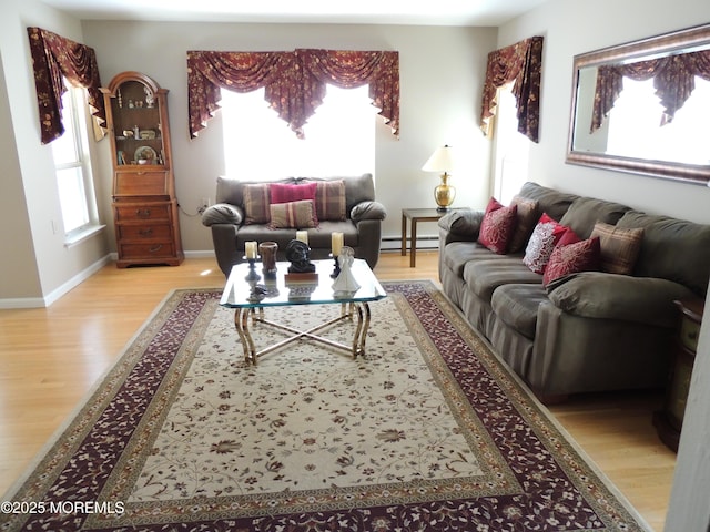 living room featuring a baseboard radiator and light hardwood / wood-style flooring