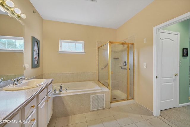 bathroom featuring vanity, plenty of natural light, tile patterned floors, and shower with separate bathtub