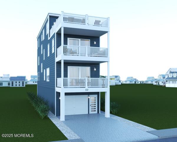 view of front facade with a balcony and a garage