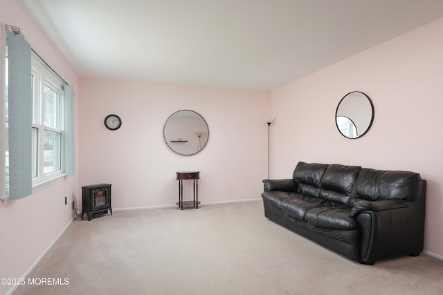 living room featuring carpet flooring and a wood stove