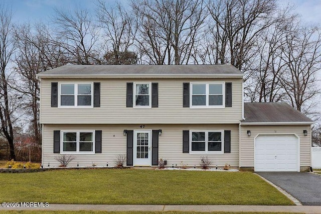 view of front of home featuring a garage and a front lawn