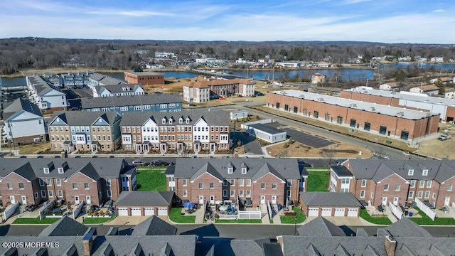 drone / aerial view with a water view and a residential view