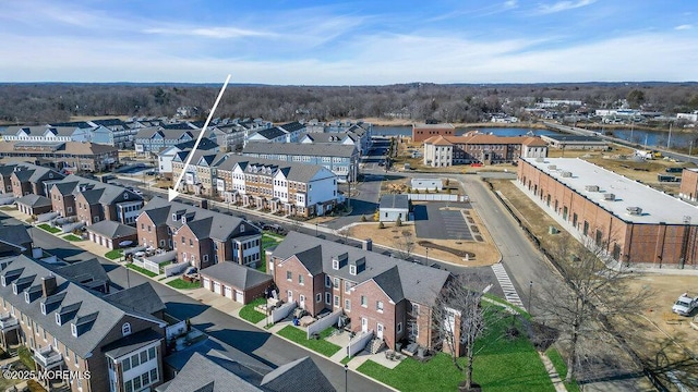 drone / aerial view with a residential view and a water view