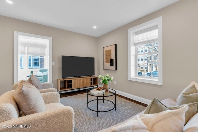 living room with baseboards, wood finished floors, and recessed lighting