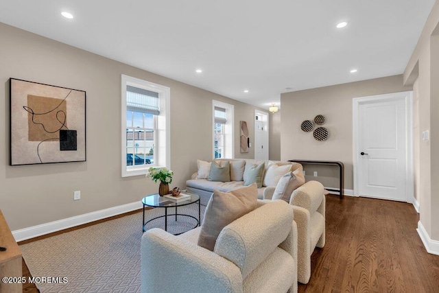 living room with dark wood-type flooring, recessed lighting, and baseboards