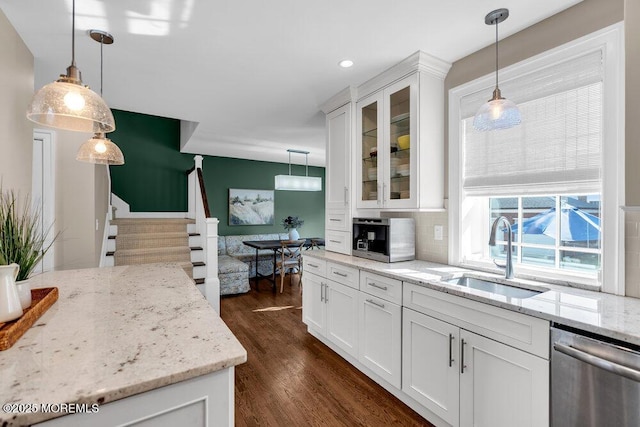 kitchen with dark wood-type flooring, glass insert cabinets, white cabinetry, a sink, and dishwasher