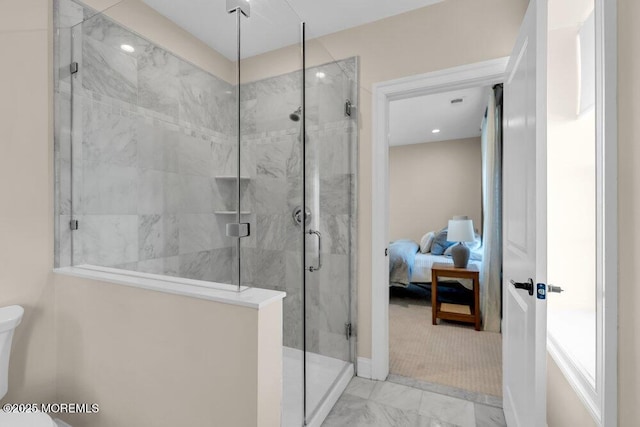 bathroom featuring a stall shower, marble finish floor, toilet, and ensuite bathroom